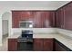 Kitchen boasts dark cabinetry, granite countertops, stainless steel appliances including a microwave and stove/oven at 1123 Hacienda Cir, Kissimmee, FL 34741