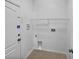 Bright laundry room featuring tile flooring, shelving and washer/dryer hookups, perfect for efficient home management at 1123 Hacienda Cir, Kissimmee, FL 34741