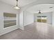 Open-concept living room featuring tiled floors and glass doors that lead to the backyard at 1123 Hacienda Cir, Kissimmee, FL 34741