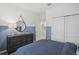 Bedroom featuring a dark dresser, blue accent wall, sliding closet doors, and interior hallway access at 1219 Normandy Dr, Haines City, FL 33844