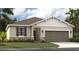 Charming single-Gathering home features a stone accent facade, two-car garage and well-manicured lawn at 1219 Normandy Dr, Haines City, FL 33844