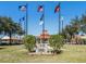 Park view featuring flags, a memorial monument, gazebo, and manicured lawns at 1219 Normandy Dr, Haines City, FL 33844