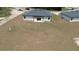 The back of the house faces a large yard, and includes a pergola and white outdoor patio at 13253 Sw 83Rd Cir, Ocala, FL 34473