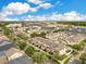 Bird's eye view of townhome community with trees and surrounding neighborhoods at 13622 Cygnus Dr, Orlando, FL 32828