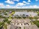 An aerial view showcases the homes, a large lake, and the surrounding area at 13622 Cygnus Dr, Orlando, FL 32828