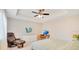 Well-lit bedroom featuring tray ceiling, modern fan, and complementary furniture at 13622 Cygnus Dr, Orlando, FL 32828