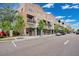 Street view of commercial spaces with sidewalk parking and various businesses under a bright sky at 13622 Cygnus Dr, Orlando, FL 32828