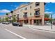 Commercial building exterior featuring multiple storefronts with awnings and upper-level balconies at 13622 Cygnus Dr, Orlando, FL 32828