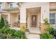 Inviting covered front porch with decorative plants and seating area at 13622 Cygnus Dr, Orlando, FL 32828