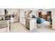 Open kitchen with stainless steel appliances and a center island with an open view of the living area at 13622 Cygnus Dr, Orlando, FL 32828