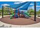 Colorful playground with slides and climbing features, sheltered by sunshades, on a soft, safe ground covering at 13622 Cygnus Dr, Orlando, FL 32828