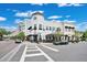Street view of storefronts with awnings and sidewalk seating for businesses at 13622 Cygnus Dr, Orlando, FL 32828