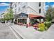 Street view of European style stores with outdoor seating and vibrant landscaping at 13622 Cygnus Dr, Orlando, FL 32828
