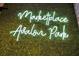 Decorative 'Marketplace Avalon Park' neon sign against a green moss wall at 13622 Cygnus Dr, Orlando, FL 32828