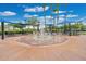 Community splash pad and picnic tables beneath shades, surrounded by palm trees, ideal for Gathering fun at 13622 Cygnus Dr, Orlando, FL 32828