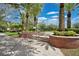 Scenic town park entrance with brick accents, palm trees, and lush landscaping at 13622 Cygnus Dr, Orlando, FL 32828