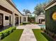 Spacious manicured backyard featuring dark wood ceiling, ceiling fans, and manicured lawn at 1400 Place Picardy, Winter Park, FL 32789