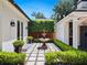 Backyard courtyard with water feature and manicured landscape creates a zen-like experience at 1400 Place Picardy, Winter Park, FL 32789