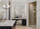 A spacious bathroom with double vanity, large mirror, walk-in shower, and neutral tile at 1400 Place Picardy, Winter Park, FL 32789