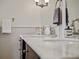 Close-up of the bathroom vanity featuring marble countertop, tile backsplash, and chrome fixtures at 1400 Place Picardy, Winter Park, FL 32789