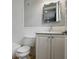 Bathroom features a white vanity with a marble countertop, subway tile, and a toilet next to the bathtub at 1400 Place Picardy, Winter Park, FL 32789