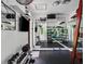 Well-equipped home gym with mirrors, weights, and various exercise machines for a complete workout at 1400 Place Picardy, Winter Park, FL 32789