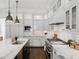 Gourmet kitchen featuring marble countertops, a center island, and stainless steel appliances at 1400 Place Picardy, Winter Park, FL 32789