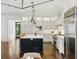 Elegant kitchen boasts white cabinetry, stainless steel appliances, and a large island with seating at 1400 Place Picardy, Winter Park, FL 32789