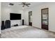 Spacious living room with carpet, TV, ceiling fan, and double french doors leading outside at 1400 Place Picardy, Winter Park, FL 32789