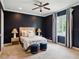 Main bedroom with dark walls, ceiling fan, carpet, and bright window with natural light at 1400 Place Picardy, Winter Park, FL 32789