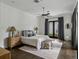 Serene bedroom features access to a patio, dark wood floors, and a walk in closet at 1400 Place Picardy, Winter Park, FL 32789