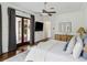 Bright main bedroom with hardwood floors, neutral tones, and a view to the outdoors at 1400 Place Picardy, Winter Park, FL 32789