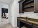 Office nook with granite countertop, wooden drawers, and bookshelf, located just off the bedroom at 1400 Place Picardy, Winter Park, FL 32789