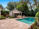 Backyard pool area offering a resort-like experience with stone patio, and outdoor furniture at 1400 Place Picardy, Winter Park, FL 32789