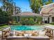 Relaxing pool with lounge area, surrounded by lush greenery, perfect for outdoor entertaining at 1400 Place Picardy, Winter Park, FL 32789