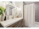 Modern bathroom showcases a spacious vanity with elegant finishes and a shower-tub combination and updated fixtures at 1578 Farrindon Cir # 1578, Lake Mary, FL 32746