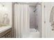 This bathroom features a tub with stylish gray tile surround and a white shower curtain at 1578 Farrindon Cir # 1578, Lake Mary, FL 32746
