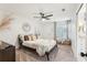 This bedroom boasts light, airy walls, a ceiling fan and neutral decor at 1578 Farrindon Cir # 1578, Lake Mary, FL 32746
