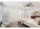 This bedroom boasts light, airy walls, a ceiling fan and neutral decor at 1578 Farrindon Cir # 1578, Lake Mary, FL 32746