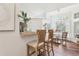 The kitchen has breakfast bar seating near the dining area with wood floors and bright natural light at 1578 Farrindon Cir # 1578, Lake Mary, FL 32746