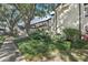 Exterior view of a well-maintained townhome with lush landscaping and mature trees offering ample shade at 1578 Farrindon Cir # 1578, Lake Mary, FL 32746