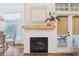 Stylish fireplace with a decorative mantel, shiplap wall and a sliding glass door leading to the patio at 1578 Farrindon Cir # 1578, Lake Mary, FL 32746