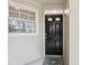 Inviting entryway with a dark front door, neutral siding, and a patterned rug at 1578 Farrindon Cir # 1578, Lake Mary, FL 32746