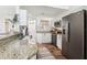 Bright open kitchen showcases granite counters, white cabinets and stainless appliances near entry to house at 1578 Farrindon Cir # 1578, Lake Mary, FL 32746