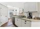 Open kitchen showcases granite countertops, white cabinets, stainless steel appliances, and eat-in dining area at 1578 Farrindon Cir # 1578, Lake Mary, FL 32746
