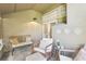 Inviting sunroom featuring whitewashed furniture, neutral paint, and tile flooring bathed in natural light at 1578 Farrindon Cir # 1578, Lake Mary, FL 32746