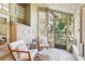 Bright sunroom featuring tile flooring, neutral paint, and two chairs providing serene relaxation at 1578 Farrindon Cir # 1578, Lake Mary, FL 32746