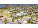 An aerial view of community amenities including a pool, tennis court, clubhouse, playground, and parking at 16054 Johns Lake Overlook Dr, Winter Garden, FL 34787