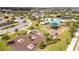 Aerial view of a community playground and picnic area with a pool, tennis court and clubhouse nearby at 16054 Johns Lake Overlook Dr, Winter Garden, FL 34787