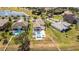 Aerial view of backyard with fenced pool, patio, and waterway access in a vibrant community at 16054 Johns Lake Overlook Dr, Winter Garden, FL 34787